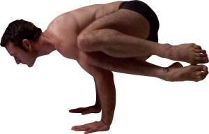 A man balances upside down in a handstand on a white surface.